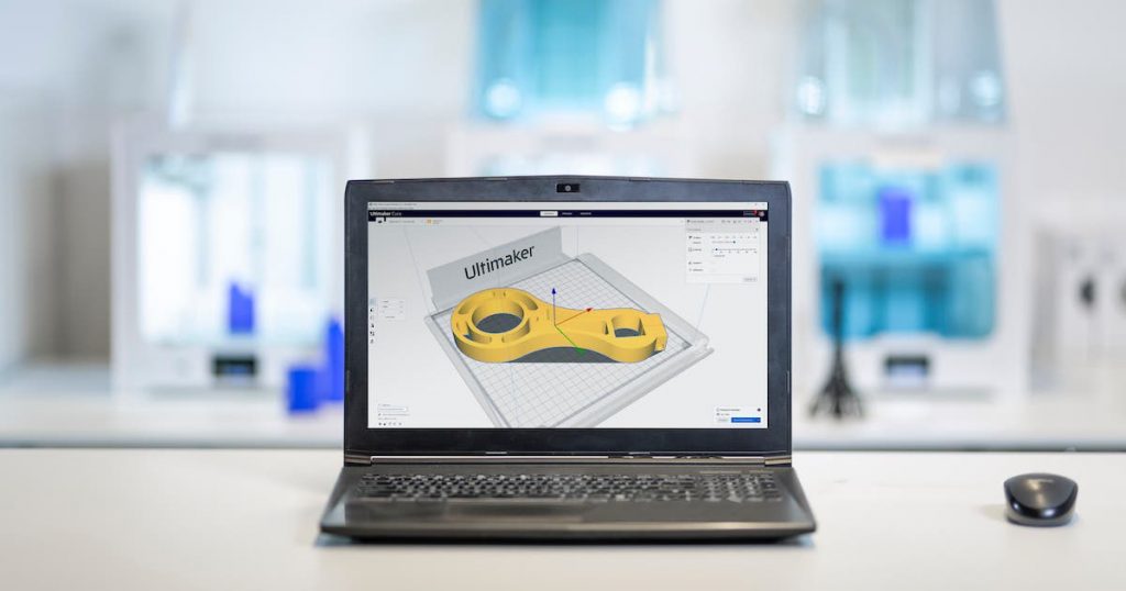 a 3d rendering of an intricate 3d part loaded on ultimaker cura software on a laptop