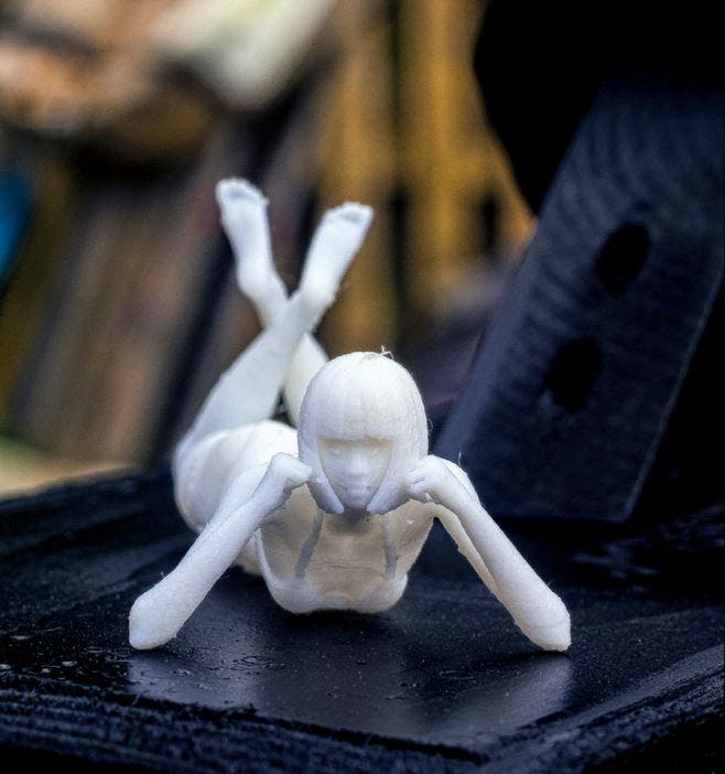 a 3d printed cyberpunk woman model in white resin