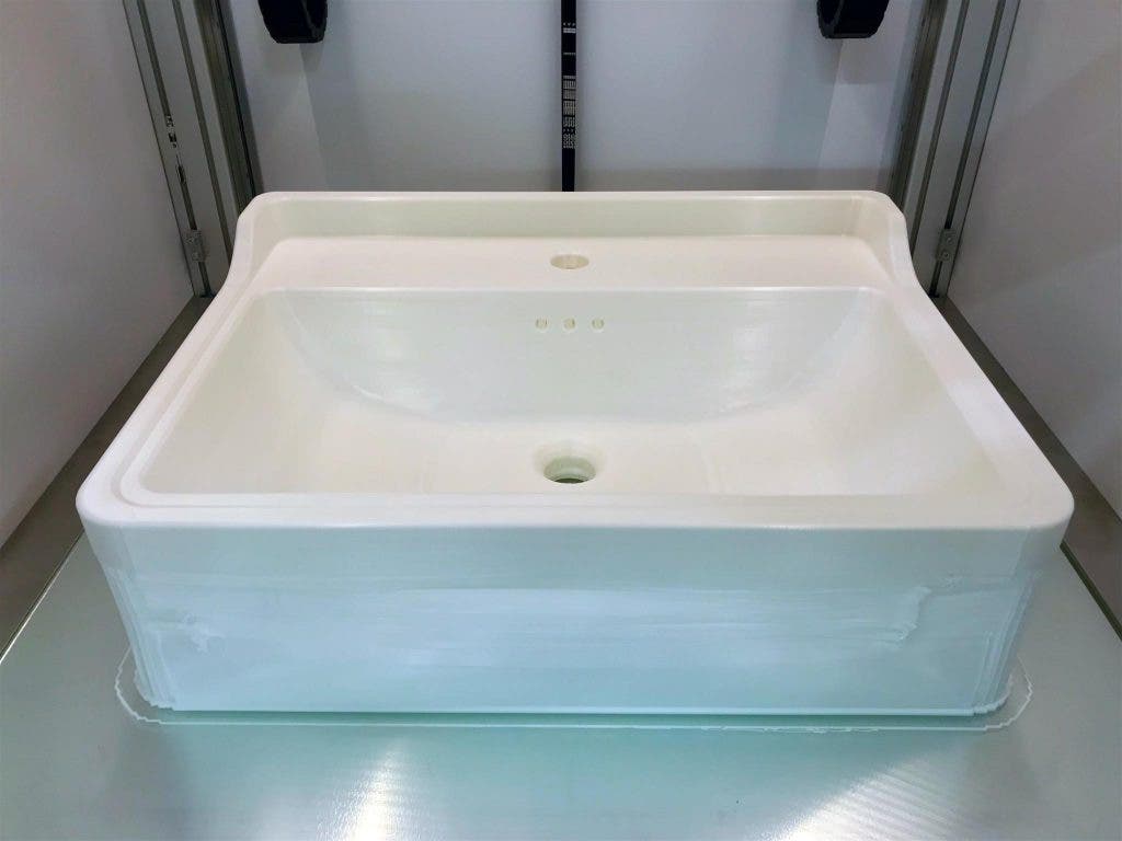 a 3d printed sink basin by Saneux, sat on the build plate of the Builder 3D printer that created it