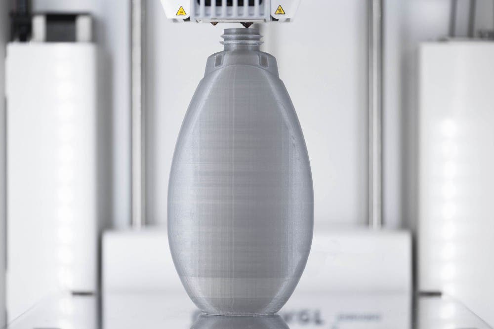 a 3d printer producing a bottle