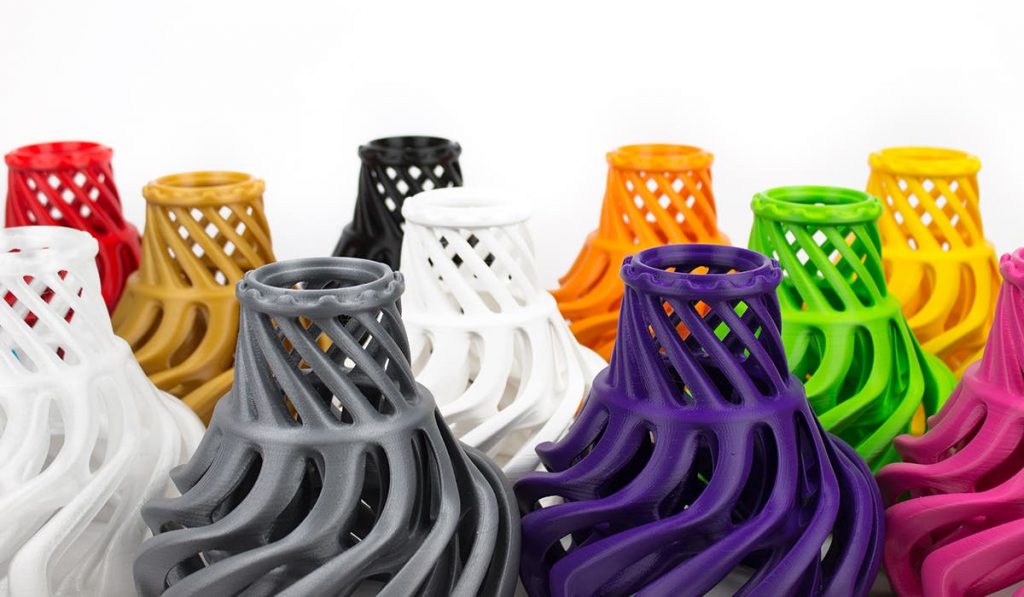 an assortment of cool artistic 3d printed vases in different colours