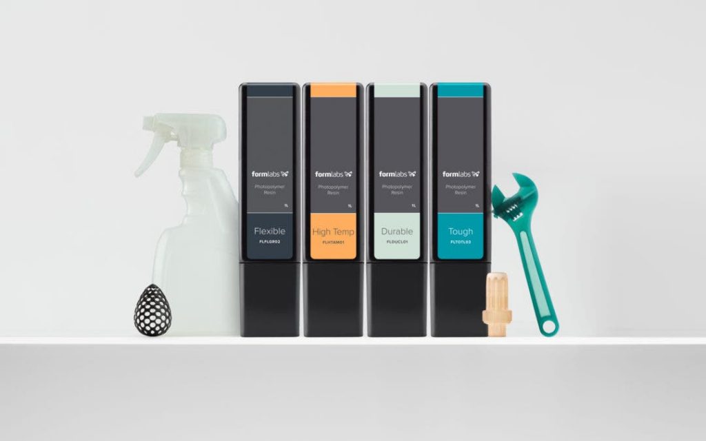 a 3d printed bottle and wrench, along with a row of formlabs resin cartridges: flexible, high temperature, durable, and tough