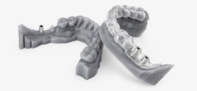 two 3d printed models of upper and lower teeth, made with dental resin
