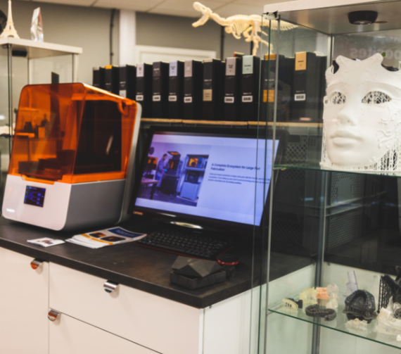 Interior photograph of the Additive-X showroom featuring formlabs' 3D printer and various models