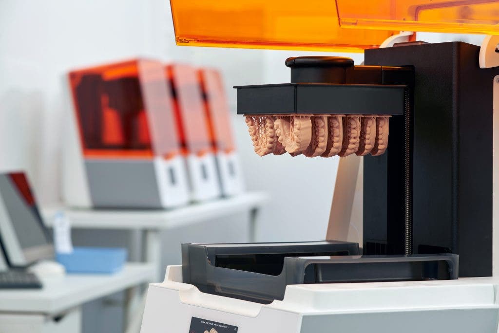 a formlabs 3b printer with lower teeth models on the build platform
