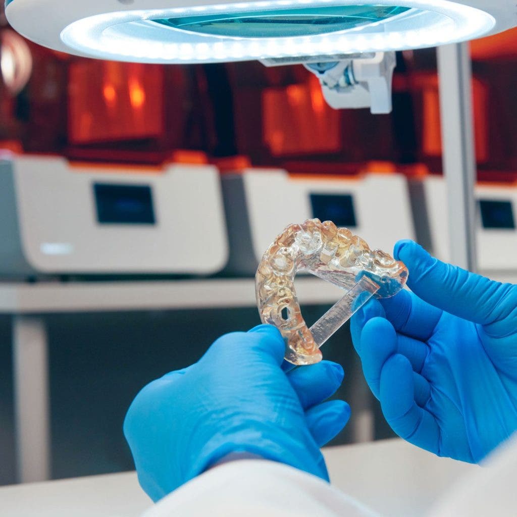 A man holding formlabs dental resin