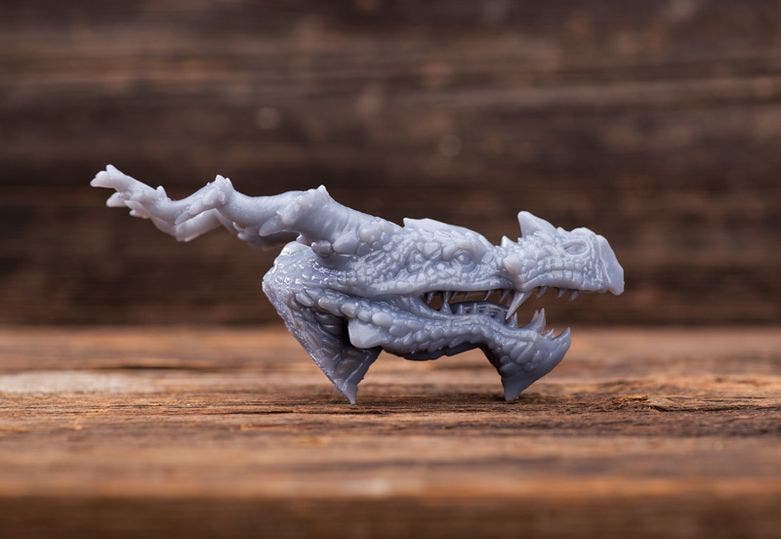 a 3d printed dragon head in grey resin