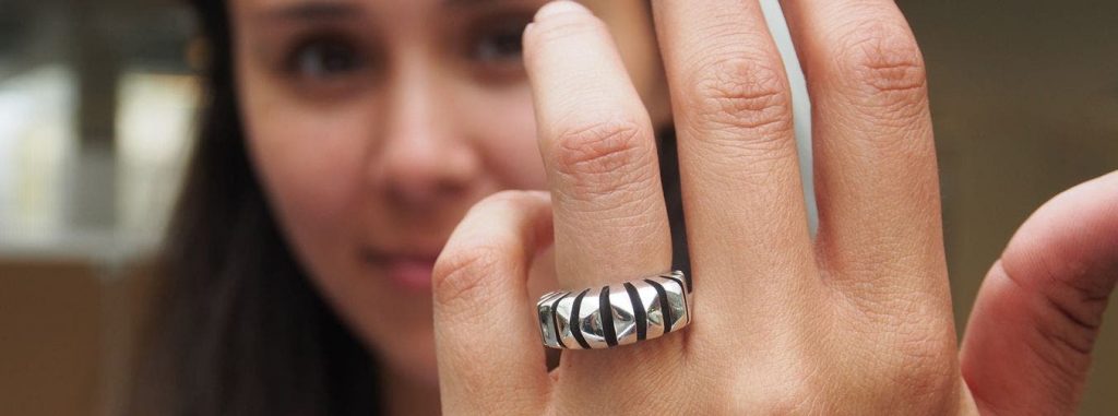 a 3d printed ring for the copenhagen school of design and technology being worn by a woman