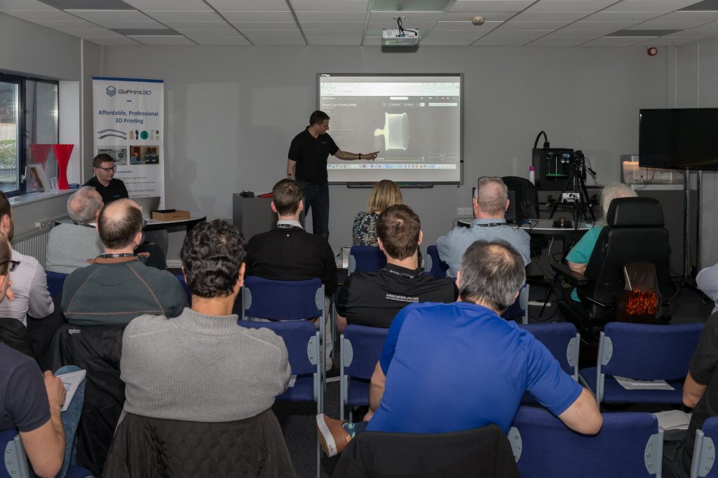 an additive x team member giving a talk about 3d printing