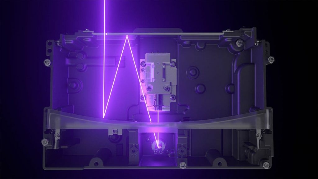 A 3D printer's interior with an artistic impression of the laser - it is a bright purple zig zag.
