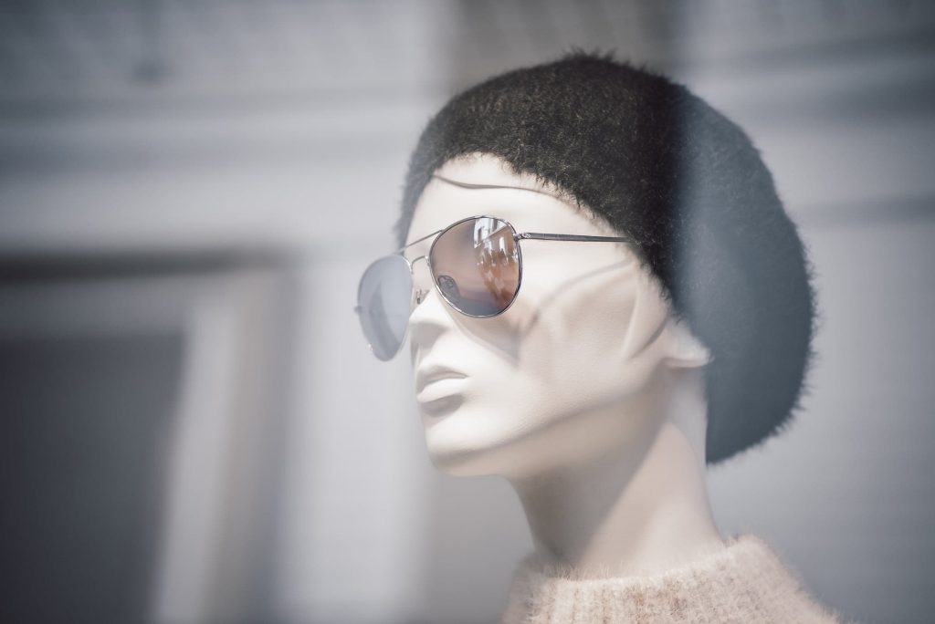 a mannequin with sunglasses and hat