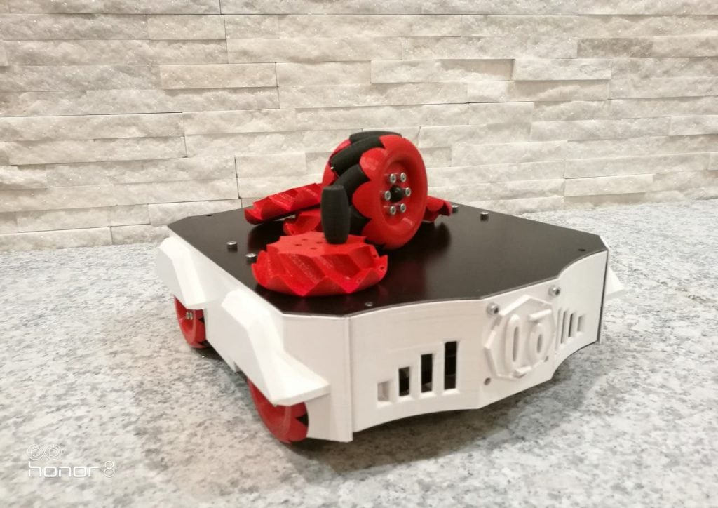 a 3d printed mecanum wheel print with the wheels sat on top