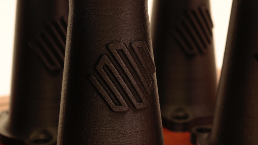 a 3d printed part in onyx material with the markforged logo on it