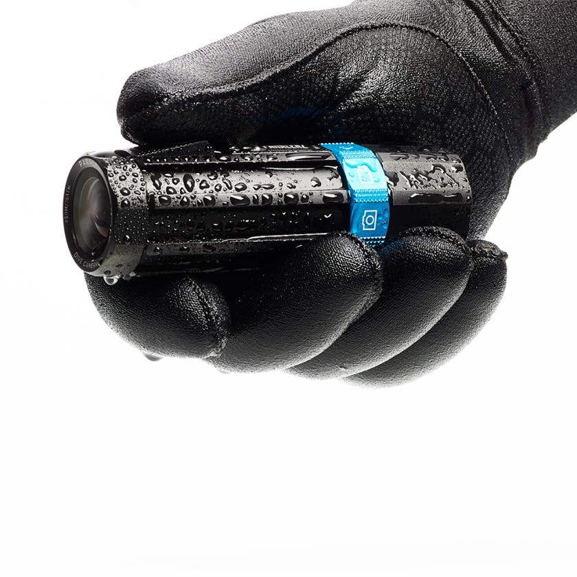 a man in a wetsuit holding the paralenz 3d printed dive camera