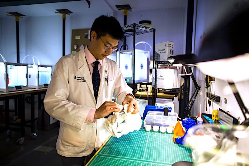 a US medical doctor examines a 3D printed part for educational purposes