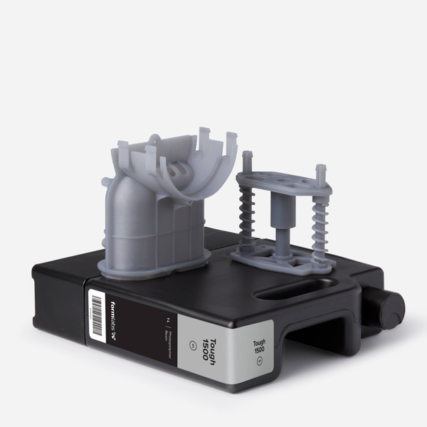 formlabs tough 1500 resin cartridge with example prints on top of it