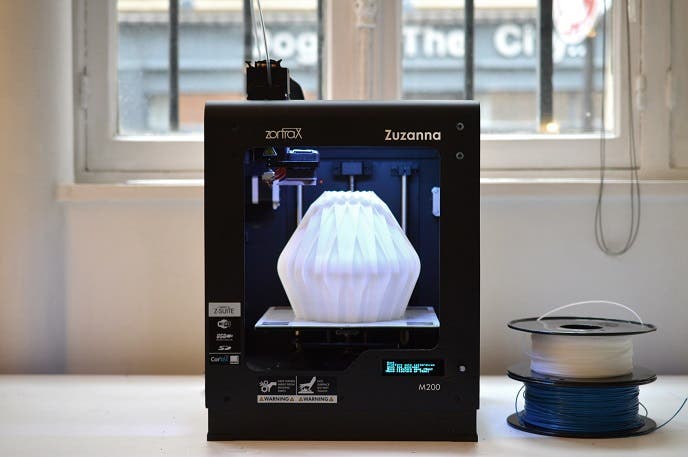 a zortrax m200 3d printer creating a white object