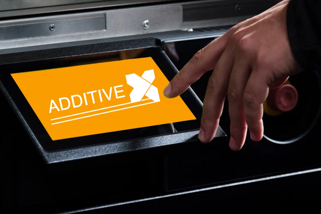 The Additive-X 3D printing parts service team operating a touchscreen interface on a 3D printer