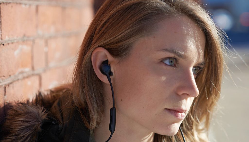 a woman wearing custom 3d printed earbuds by formlabs