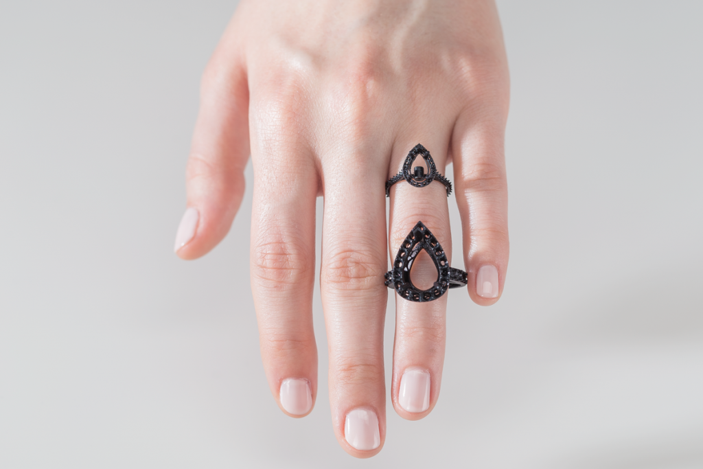 a woman wearing 2 3d printed rings as jewellery