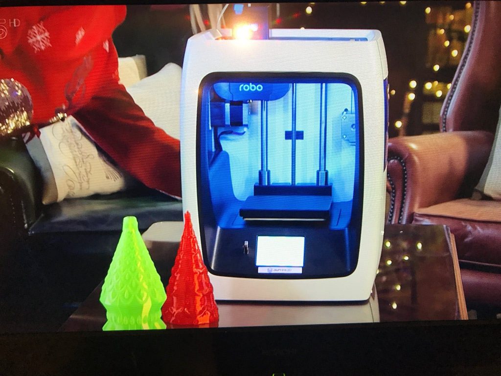 A robo c2 3d printer in a christmas-themed living room