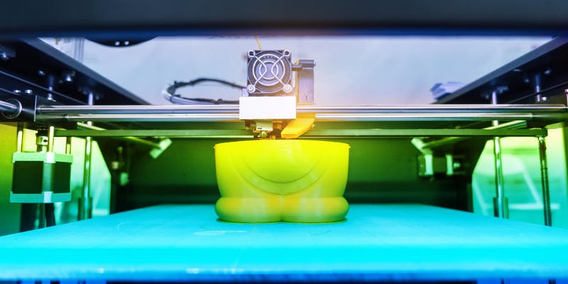 a 3d print job taking place. A cartoon figurine is being printed.