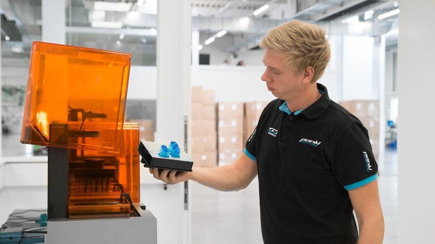 pankl racing systems man removing a resin print from a formlabs printer