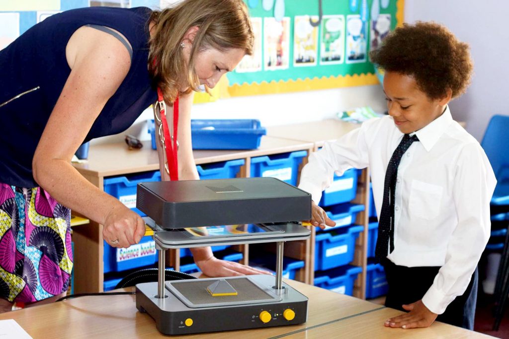 teacher and child using a mayku formbox
