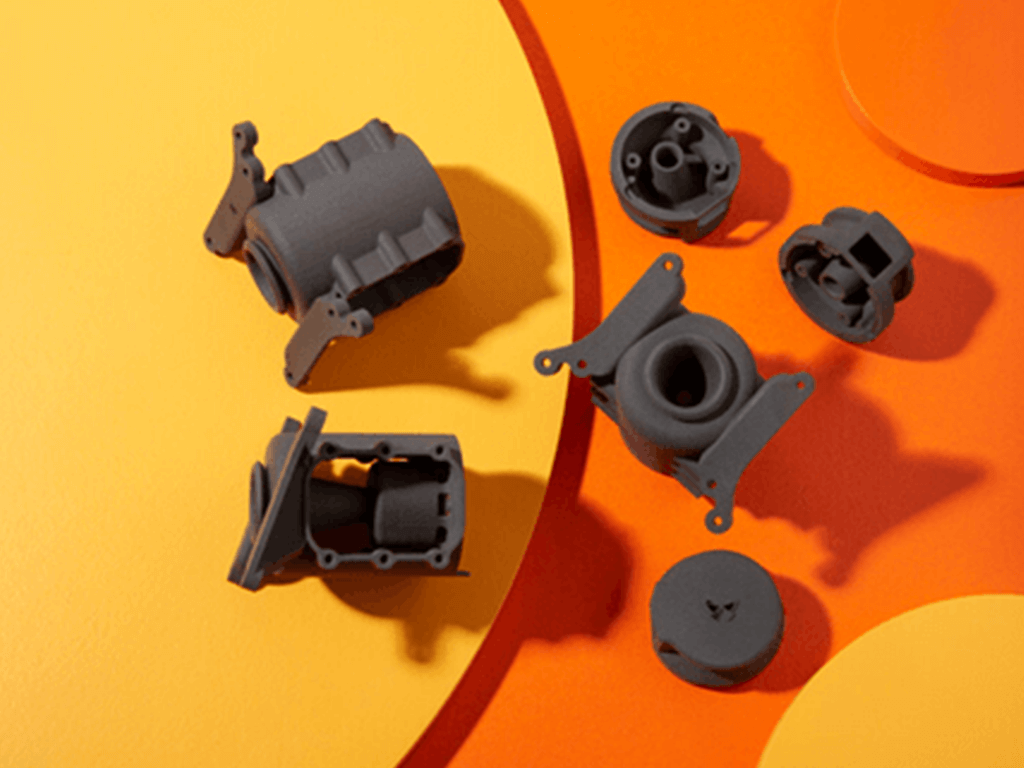 an assortment of 3d printed parts in SLS
