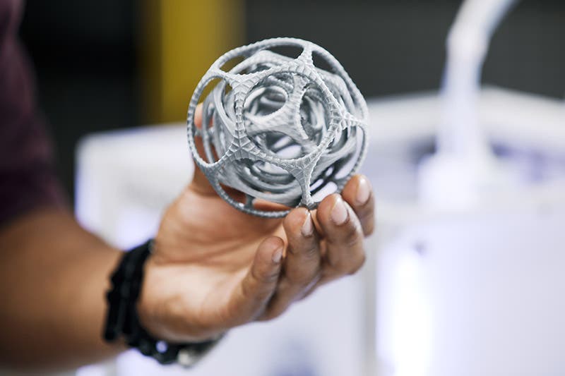 3d printed gyroscope being held in a man's hand