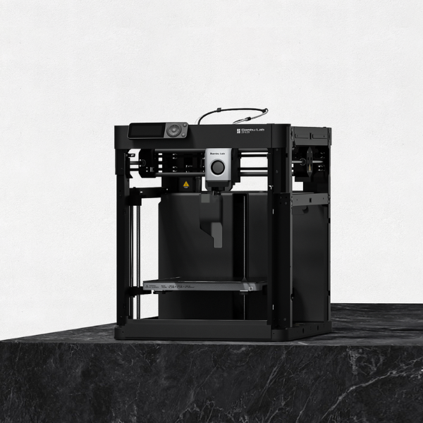 A Bambu Lab P1P 3D printer sat on a granite slab.