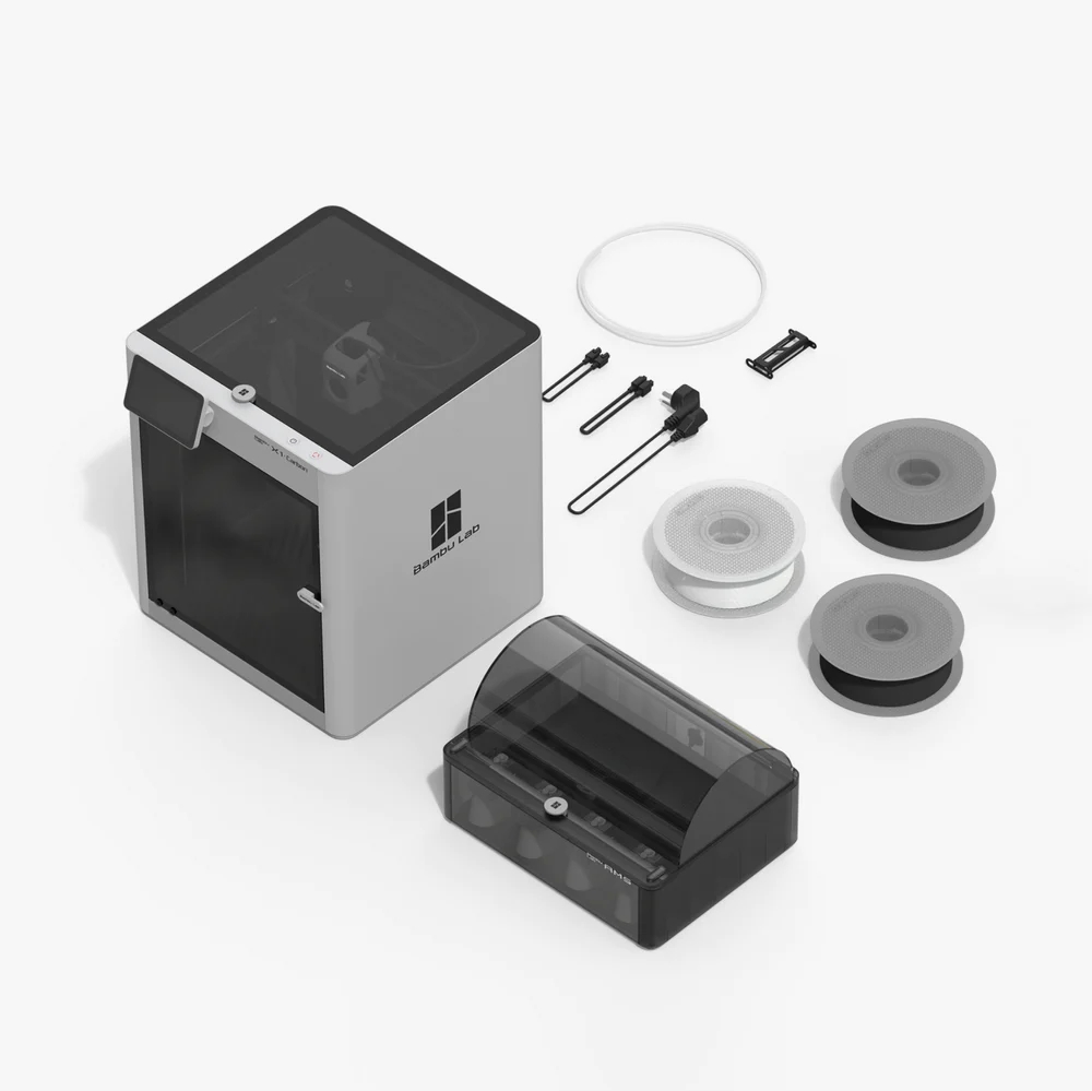 The Bambu Lab X1 Carbon 3D printer with a disassembled automatic material system next to it.