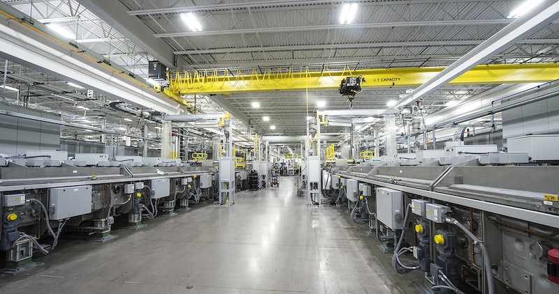 The interior of a factory showing 2x long production lines