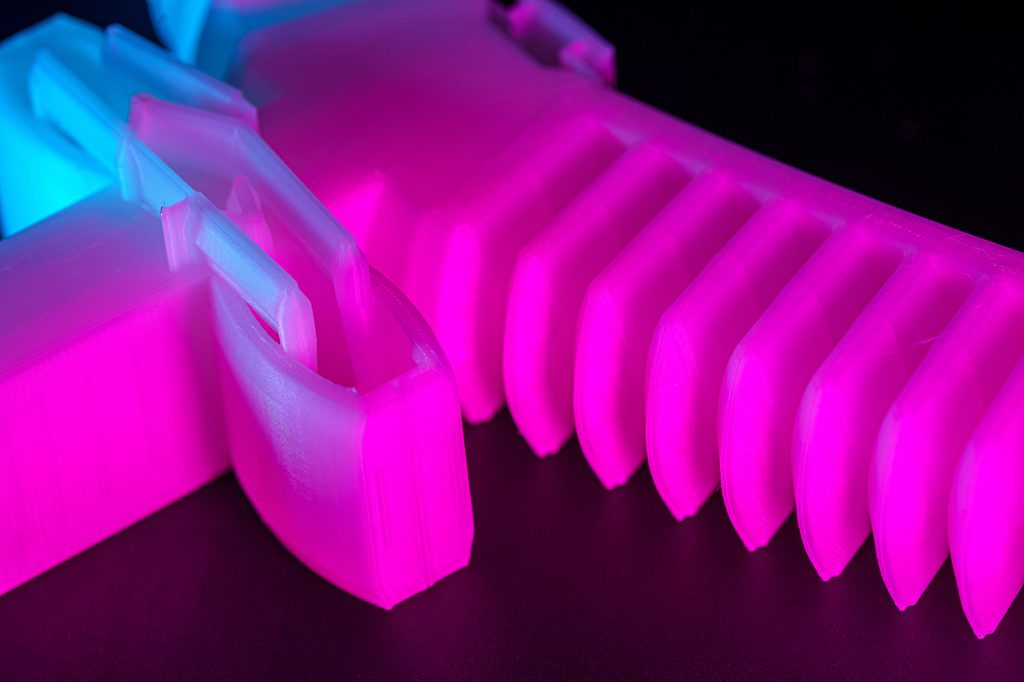 A pink robotic soft plastic gripper.