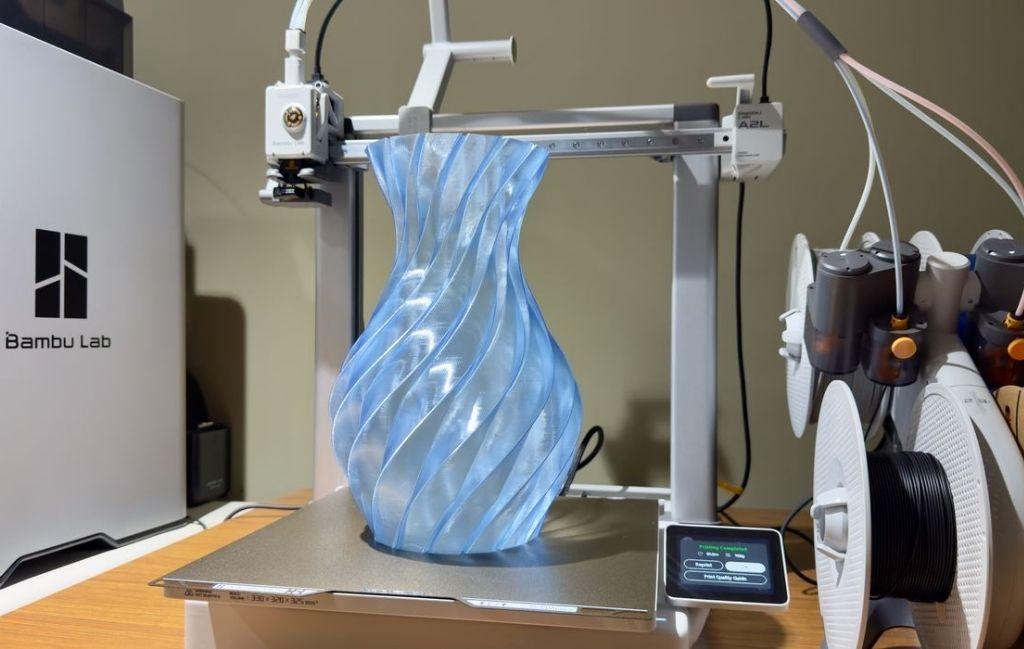 Bambu Lab A2L large bed 3D printer producing a tall vase on its build plate